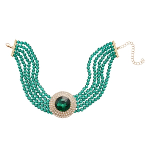 Vintage green glass bead necklace with a crystal-studded round pendant and gold chain