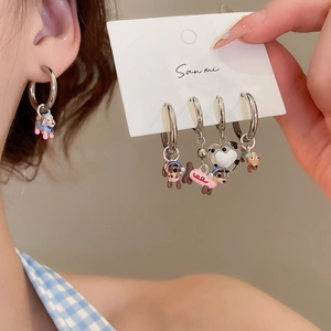 Detail view of silver enamel dachshund dog hoop earrings with colorful animal charms