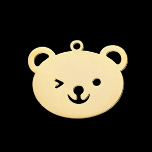 Close-up of golden stainless steel teddy bear pendant with a brushed metal finish