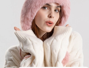 Close-up of pink faux fur trapper hat with knit ear flaps for winter warmth