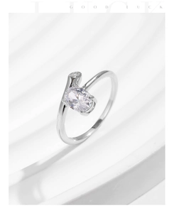 Close-up of s925 silver ring featuring oval zircon stones on a white textured surface