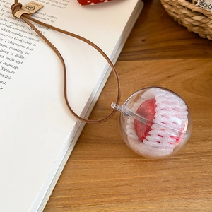 Detail of creative acrylic snowflake earring with red interior and soft mesh wrap