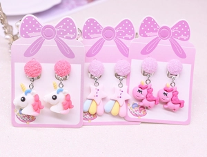 Three pairs of cute unicorn and rainbow clip-on earrings for kids with glitter details