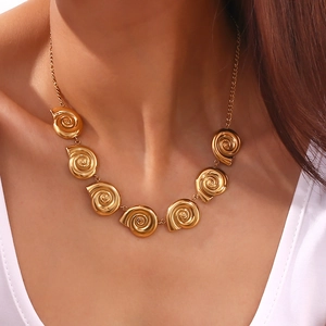 Detail of 18K gold plated spiral snail shell pendant on NK chain necklace for women