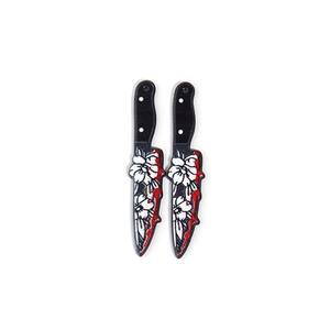 Detail of acrylic Halloween knife charms with floral patterns and red blood splatters