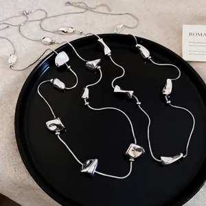 Polished silver irregular square bead necklace with sleek snake chain on black tray