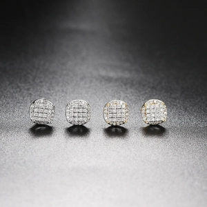 Macro shot of hip hop micro-paved zircon stud earrings in gold and silver plating