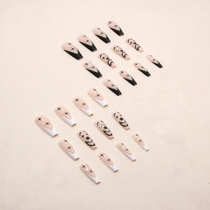 Long ballet press-on nails featuring black and white smiley faces and star patterns