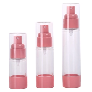 Three pink clear vacuum spray bottles for travel cosmetics in various sizes on white background