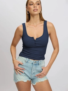 Slim fit navy blue ribbed tank top with U-neck and buttons paired with denim jeans