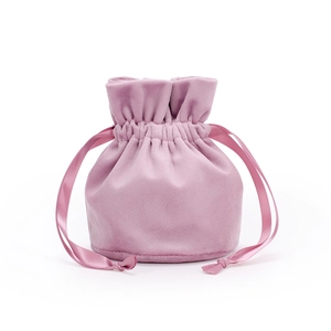 Detailed view of pink velvet drawstring pouch with soft texture and ribbon closure