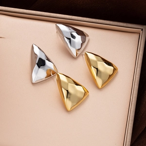 Minimalist geometric triangle stud earrings in gold and silver with textured metal finish