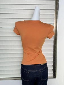 Back view of orange slim-fit knit T-shirt with hourglass waist and round neck design