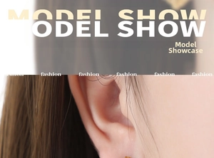 Detailed close-up showing minimalist gold heart earrings on model's earlobe
