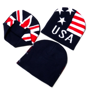 Detail of knitted beanie set with UK and USA flag patterns in red, white and blue