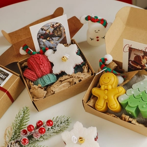 Detailed set of Christmas scented candles with gingerbread man and tree shapes in a gift box
