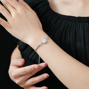Bracelet chaîne en argent avec zircon carré et détails de croix porté par un mannequin