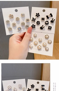 Detailed set of elegant pearl and rhinestone safety pins in various decorative shapes