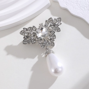 Silver crystal butterfly brooch with water diamonds and pearl on geometric white stand
