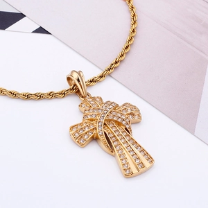 Close-up of a gold-plated hip hop cross pendant with sparkling diamonds and twist chain
