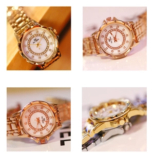 Close-up of rose gold watch with faceted bezel and sparkling rhinestone dial details