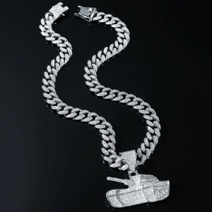 Close-up of sparkling iced out tank pendant on a silver Cuban link chain for men