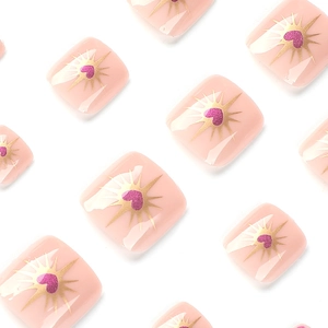 Pale pink press-on toenails with gold starburst patterns and purple glitter heart designs