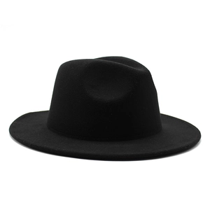 Close-up of a premium black wool fedora hat featuring a wide brim and classic crown