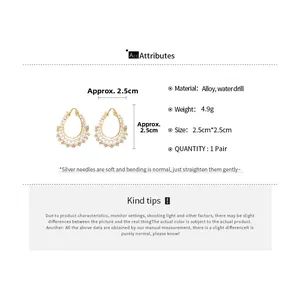 Detailed view of alloy star and pearl earrings with silver needles and crystal pavé