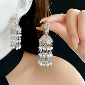 Elegant vintage silver tassel earrings with pearls and rhinestones on a female model