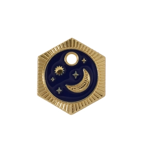 Detail of hexagonal gold astronaut charm with deep blue enamel moon and stars design