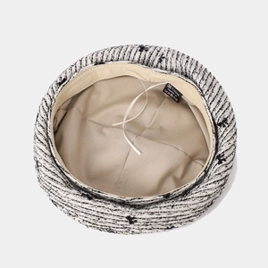 Detail of tweed beret hat interior with adjustable drawstring and quality lining