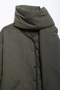 Detail of army green quilted cotton jacket and matching scarf with snap closure