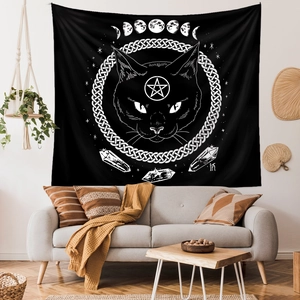 Detail of bohemian black cat tapestry with moon phases on a living room wall