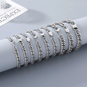 Close-up of silver stainless steel cuban curb chain bracelets with lobster clasp detail