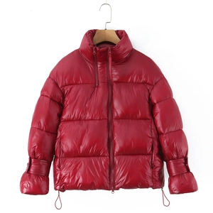 Detail of red stand collar puffer jacket featuring adjustable cuffs and drawstring hem