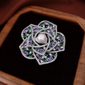 Elegant flower brooch with central pearl and colorful zircons in a premium jewelry box