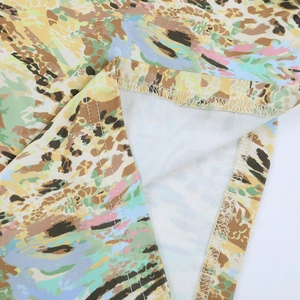 Macro detail of high-quality hem stitching and colorful leopard print fabric texture