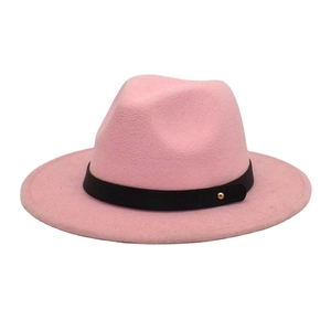 Detail of pink wool fedora hat featuring a black faux leather band and gold metal buckle