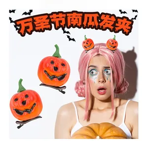 Detail of Halloween pumpkin hair clips featuring funny face and black metal duckbill clip
