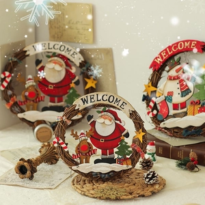 Christmas welcome wreath with Santa and snowman figures on a woven vine base