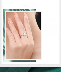 Close-up of S925 sterling silver ring with oval opal gemstone and fine micro-pave diamonds