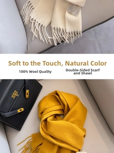 Detail of soft 100% Australian wool scarves in off-white and ginger with fringe edges