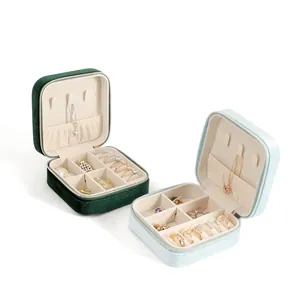 Velvet and fabric portable jewelry boxes in dark green and light blue with ring slots