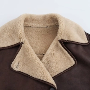 Detailed close-up of brown faux leather jacket with soft cream shearling wool lining