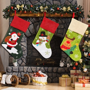 Three embroidered Christmas stockings with Santa, Snowman and Reindeer on a fireplace
