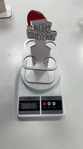 Detailed top view of a 53g mini Christmas wine bottle holder decoration on a scale