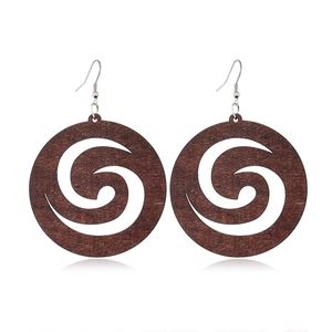 Detailed view of dark brown round wooden earrings with hollow spiral design on white background