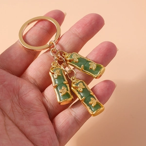 Gold bamboo-shaped keychain with green faux jade accents and durable metal ring