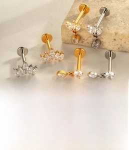 Detailed view of titanium labret stud with cubic zirconia in leaf and curved shapes